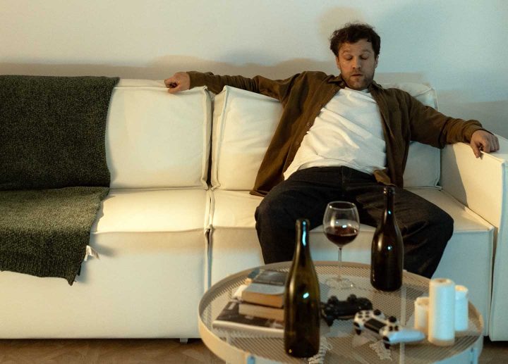 A drunk man in the couch of his living room