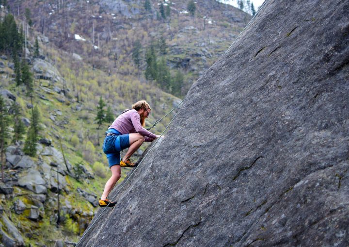 A man being challenged in climbing a mountain